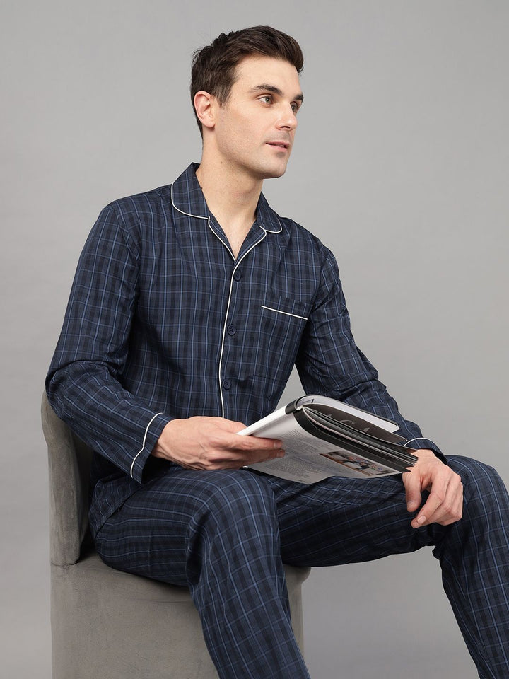 Navy Blue windowpane checked lapel collar casual nightsuit, has 1 patch pocket and long sleeves. Trousers with 2 pockets, slip on waist and drawstring.