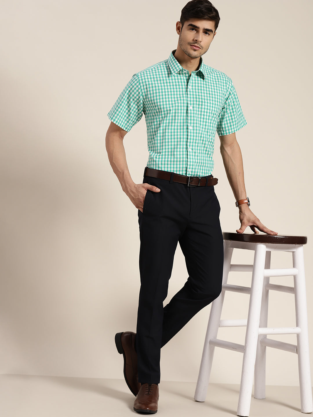 Man in Green Shirt and White Pants Sitting on Chair · Free Stock Photo